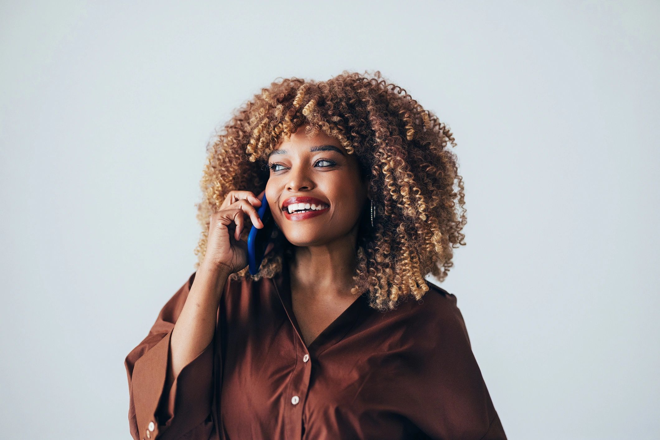 Team member smiling while talking on the phone